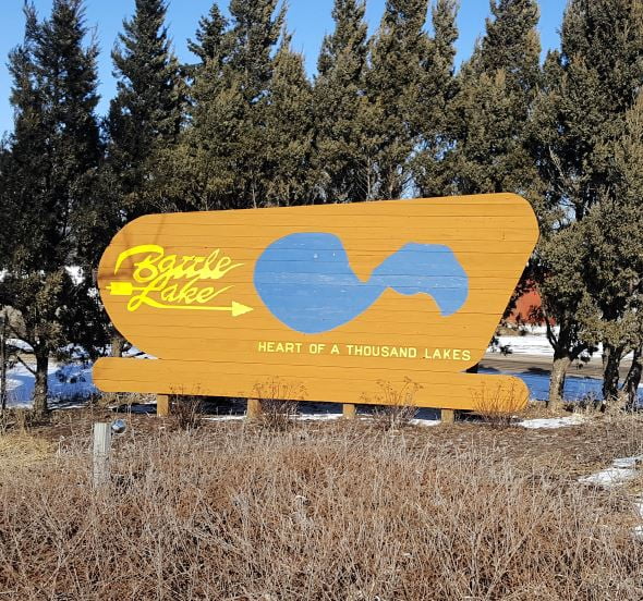 City of Battle Lake Sign that show the lake printed above the text "heart of a thousand lakes"