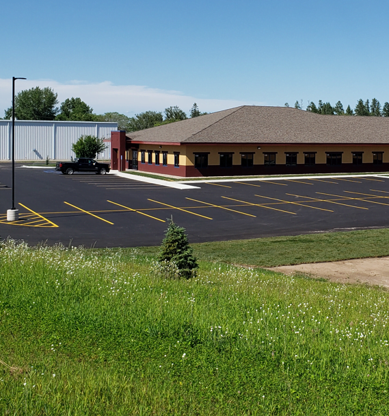 3D rendering of a red and yellow school building.